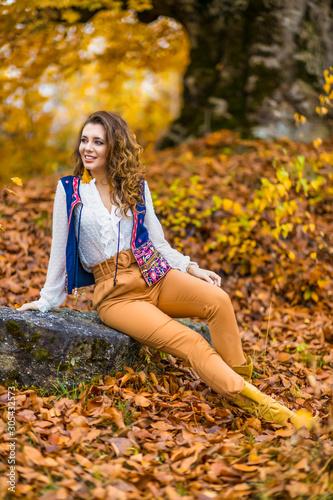Portrait of a beautiful woman in autumn landscape