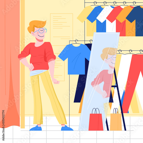 Young man choosing clothes. Guy trying on new clothes