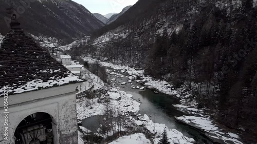 Cinematic aerial view at Lavertezzo, Switzerland in winter season. Lavertezzo is a small village with a valley and mountains along the river Verzasca in the Swiss canton Ticino.