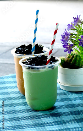 Thai tea and green tea blended on top with grass jelly. photo