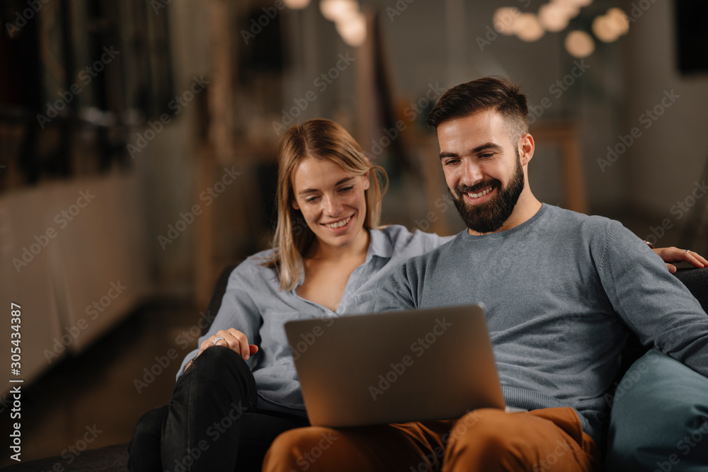 Young happy couple. Partners using laptop tohether. Young happy couple. Partners using laptop tohether.