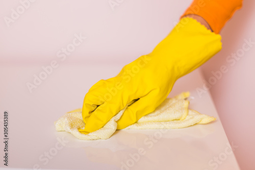 Image of housewife cleaning table with mop.