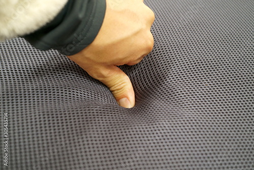 Fotografija Hand to check the softness of the cushion