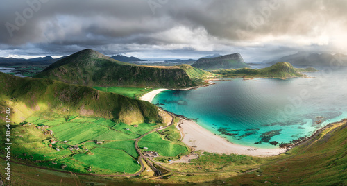 turquoise white sand beach and lush green grass during sunset Norway Loforen