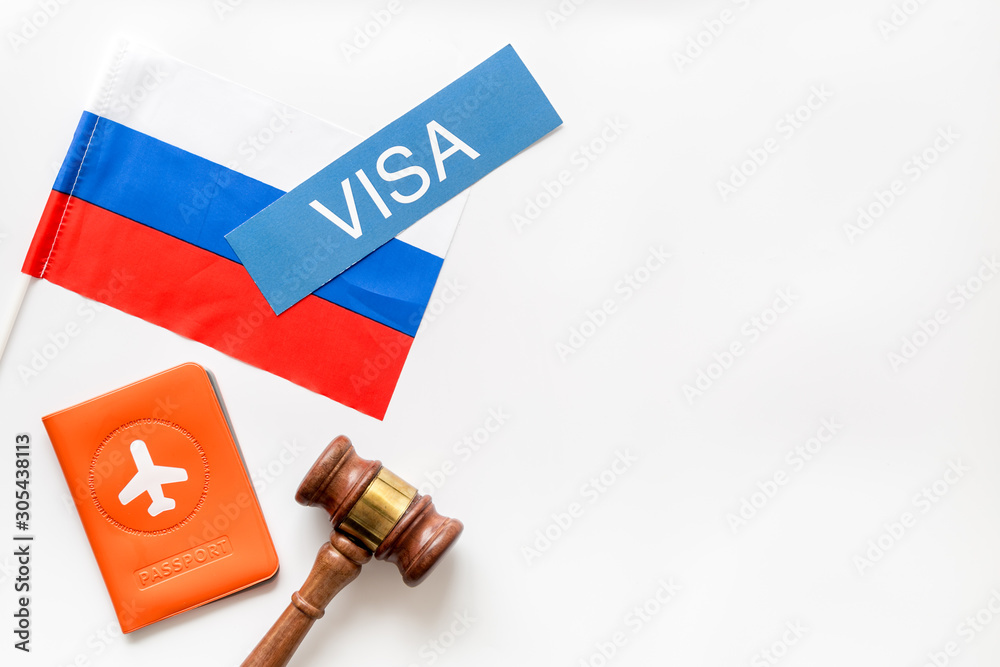 Visa to Russia concept. Russian flag near passport and judge hammer on white background top view copy space