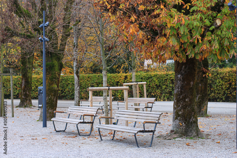 Empty benches on the bank of Wolfgangsee lake in autumn, Sankt Gilgen, Austria