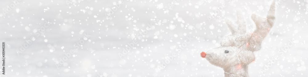 Silver glitter Christmas deer on white background with lights bokeh. Greeting card, banner. holiday concept. Panorama picture Silver glitter Christmas deer on white background with lights bokeh. Greeting card, banner. holiday concept. Panorama picture