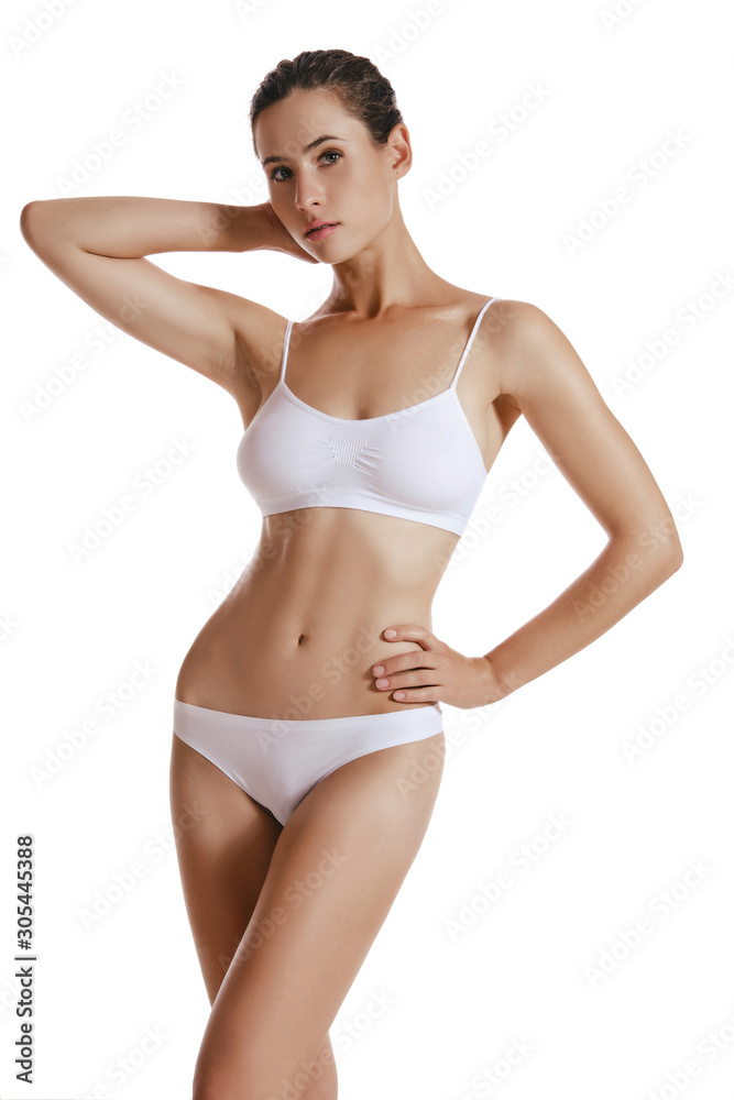 Young woman in white underwear, with bundled hair, posing in studio, isolated on white. Plastic surgery, aesthetic cosmetology. Close-up. Young woman in white underwear, with bundled hair, posing in studio, isolated on white. Plastic surgery, aesthetic cosmetology. Close-up.