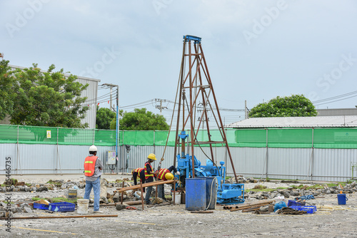 Construction workers drilling obtaining soil samples field for geological logging  analysis and testing  soil investigation before design pile tip for construction site.