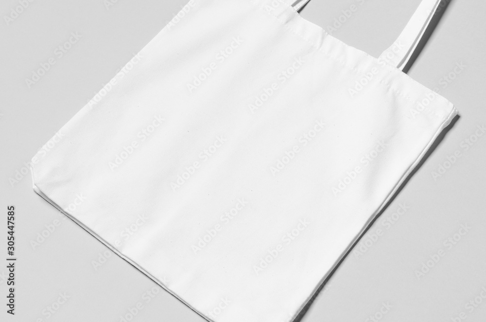White tote bag mockup on a grey background. Stock Photo | Adobe Stock