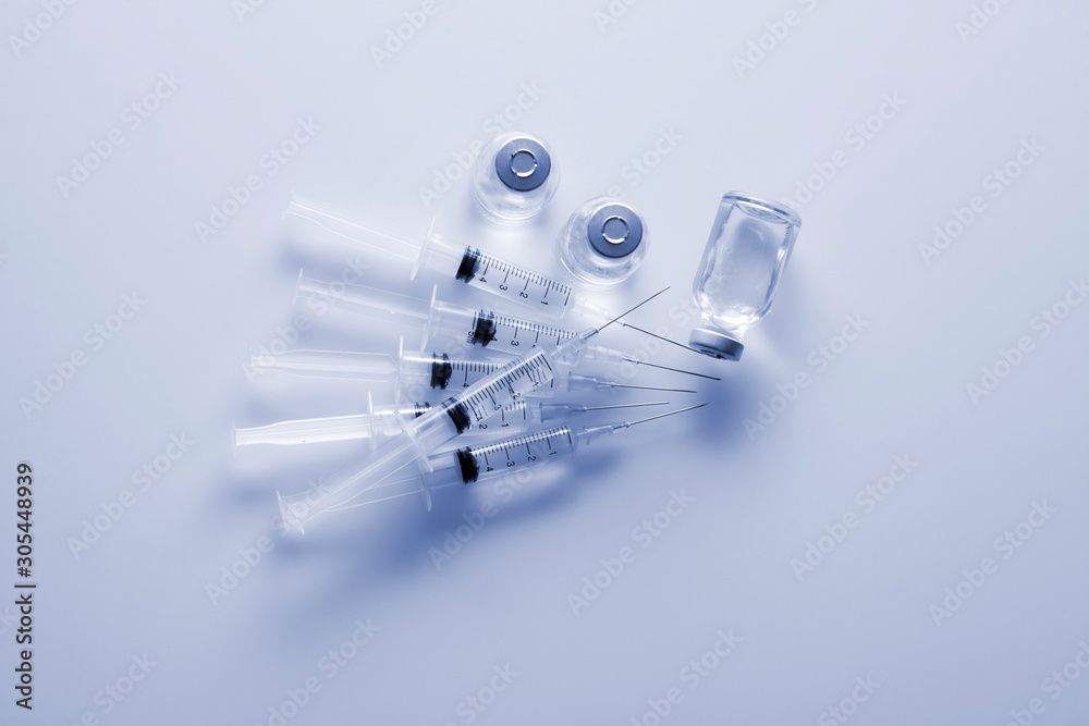 Glass medicine vials and Syringe on white background Glass medicine vials and Syringe on white background