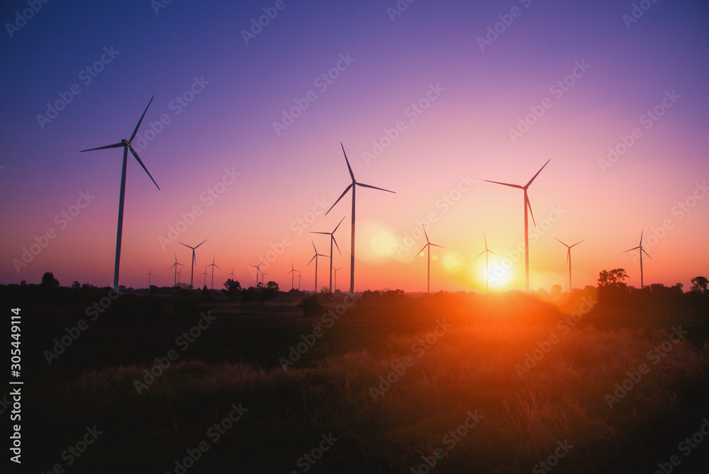 Obraz premium Silhouette of the wind turbine at sunrise in Huay Bong Wind Farm, Dan Khun Thot, Thailand. - Image