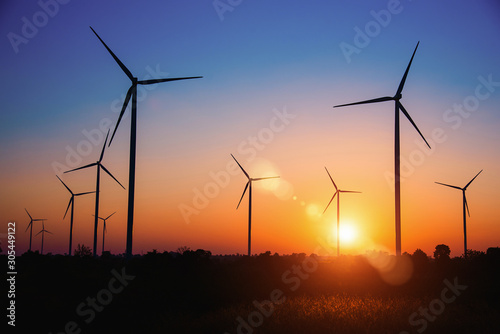 Silhouette of the wind turbine at sunrise in Huay Bong Wind Farm, Dan Khun Thot, Thailand. - Image