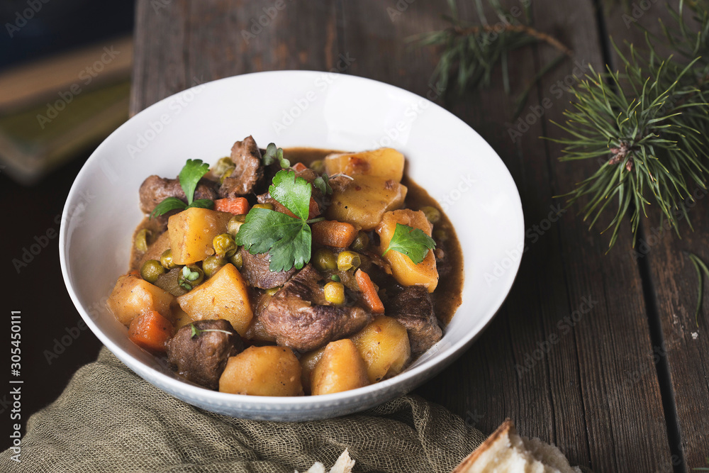 traditional irish beef and guinness beer stew with carrots, potatoes and green peas traditional irish beef and guinness beer stew with carrots, potatoes and green peas