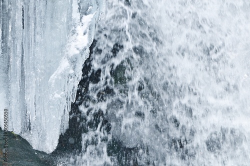 Beautiful mountain waterfall covered in ice