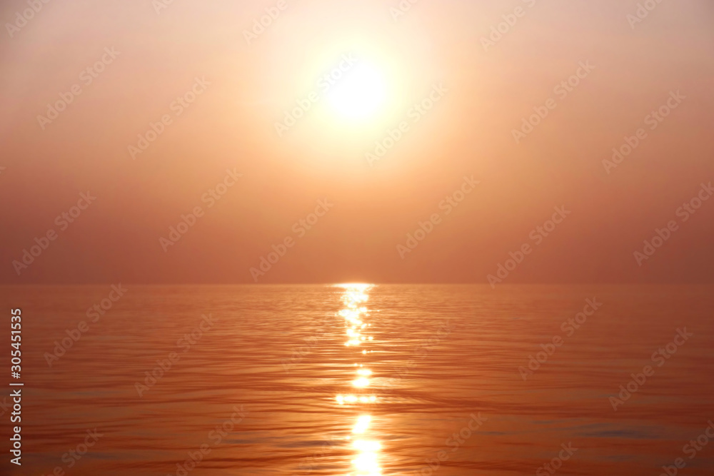Dramatic image of the ocean in summer time. Beautiful sunset sky over the sea at in the evening. Sunrise in the morning of the sunny day in warm tone. Background or copy space.