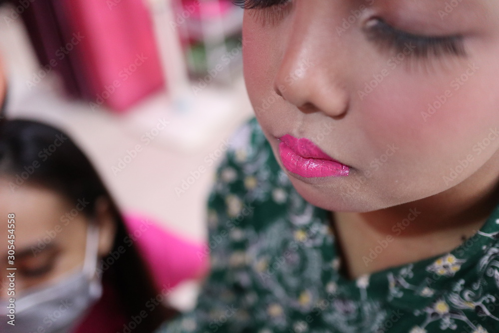 Make-up artist work on her client, beautiful teen girl, Pekalongan Indonesia Make-up artist work on her client, beautiful teen girl, Pekalongan Indonesia