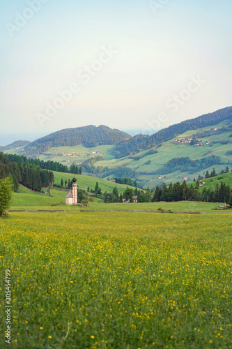 St Johann Church on the field of flowers and green hills on background.