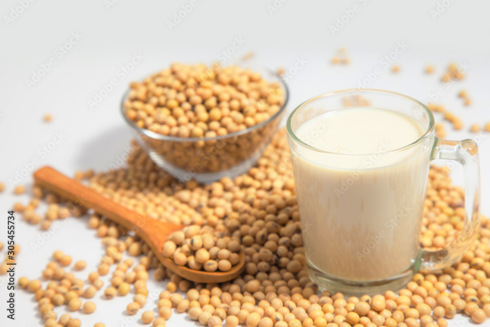 Soy milk pouring in glass and soy bean or soya bean . Alternative Soy milk healthy concept. Soy milk pouring in glass and soy bean or soya bean . Alternative Soy milk healthy concept.