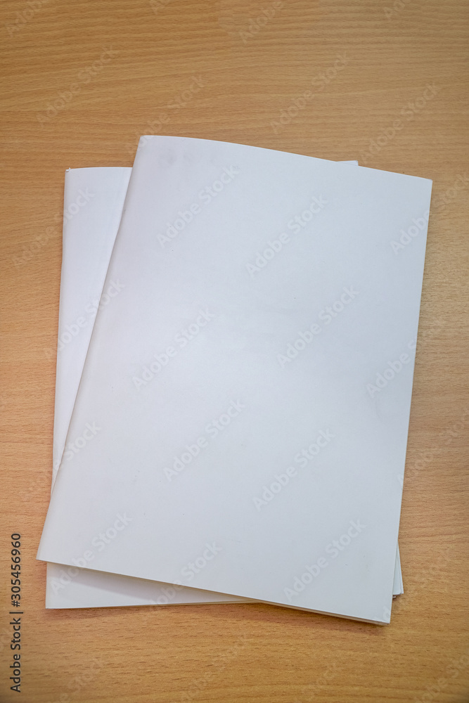 Blank brochure form with a clear title page for your project on a wooden table Blank brochure form with a clear title page for your project on a wooden table