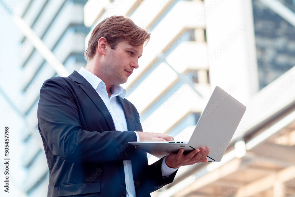 young business man uses a laptop to find information about investments and businesses young business man uses a laptop to find information about investments and businesses