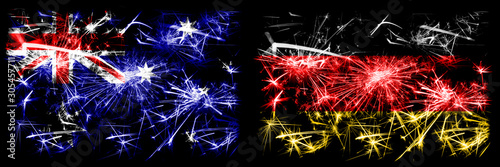 Australia, Ozzie vs Germany, German New Year celebration sparkling fireworks flags concept background. Combination of two abstract states flags. © Vlad