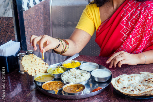 Photography close up photo of Indian traditional vegetarian thali from rice, dal, potatoes,
