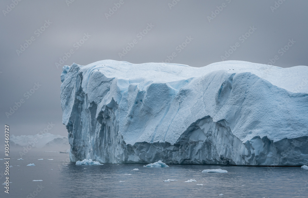 Greenland. The biggest glacier on a planet Jakobshavn. Huge icebergs of different forms in the gulf. Studying of a phenomenon of global warming and catastrophic thawing of ices.