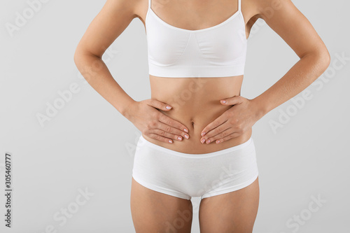 Young woman on grey background, closeup. Gynecology concept