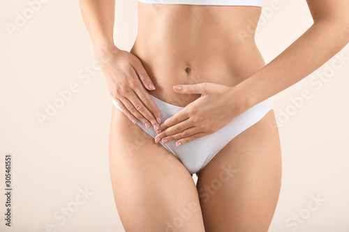 Young woman on light background, closeup. Gynecology concept
