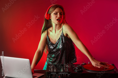 Female dj playing music in ...