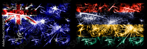 Australia, Ozzie vs Mauritius, Mauritian New Year celebration sparkling fireworks flags concept background. Combination of two abstract states flags. © Vlad