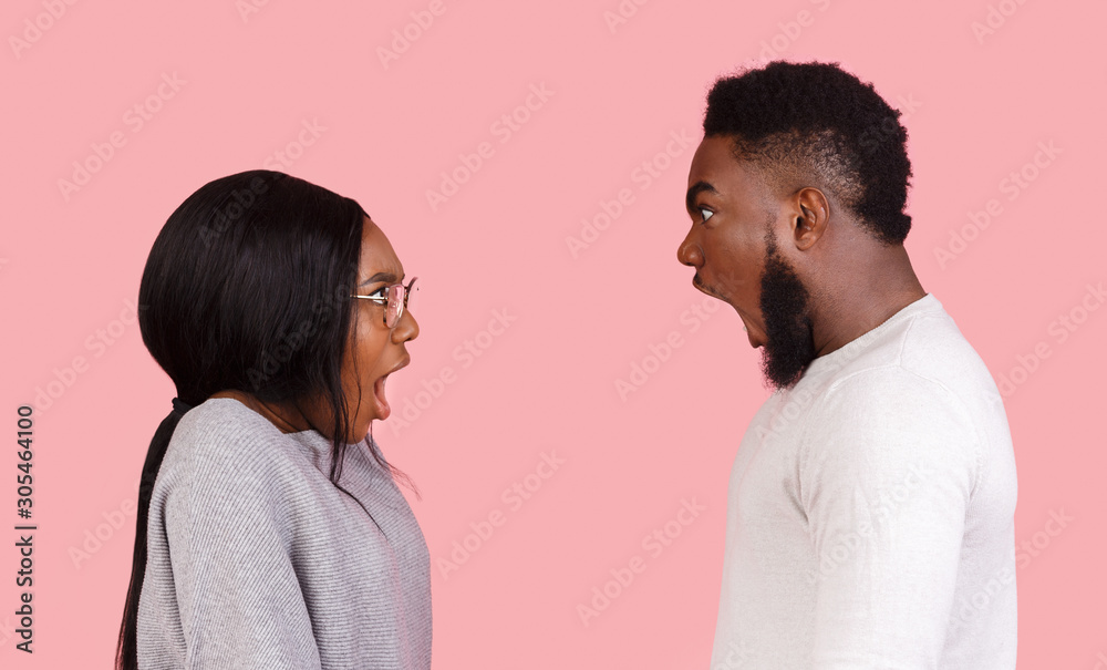 Young couple yelling at each other in studio Young couple yelling at each other in studio