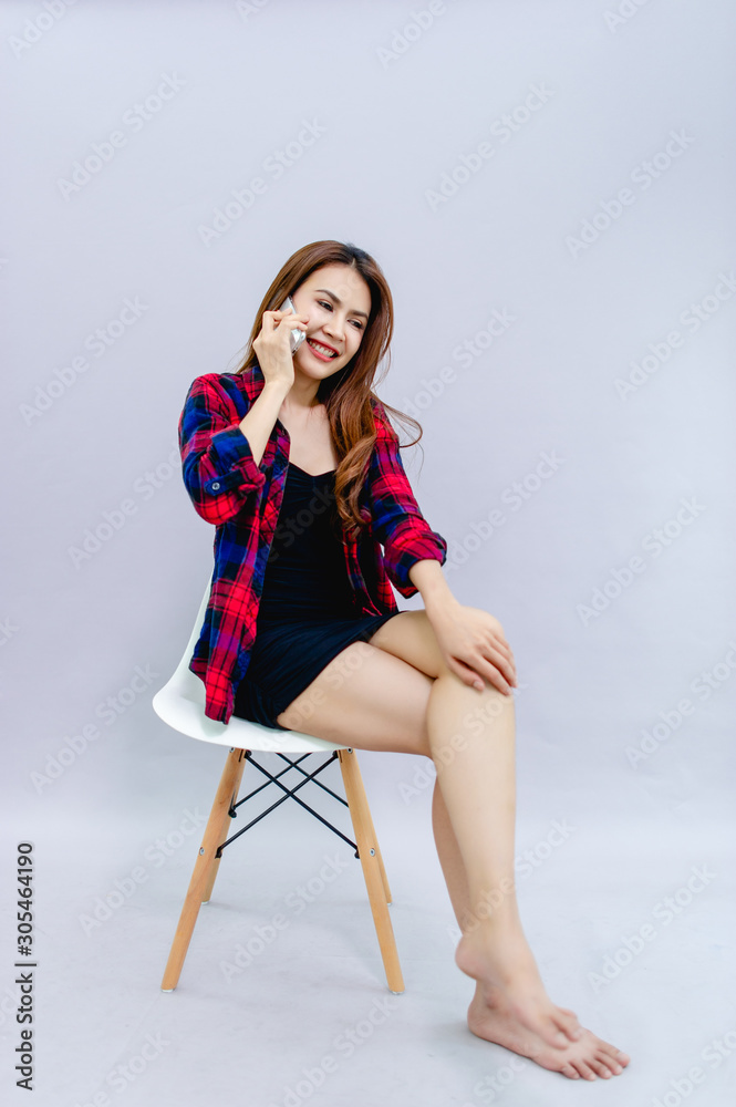 Woman talking on the phone and smiling happily It is good communication. The concept of communication with people Woman talking on the phone and smiling happily It is good communication. The concept of communication with people