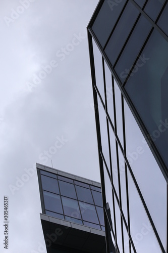 Abstract business modern city urban futuristic architecture background  motion blur  reflection in glass of high rise skyscraper facade  toned blue picture with bokeh. Real estate concept