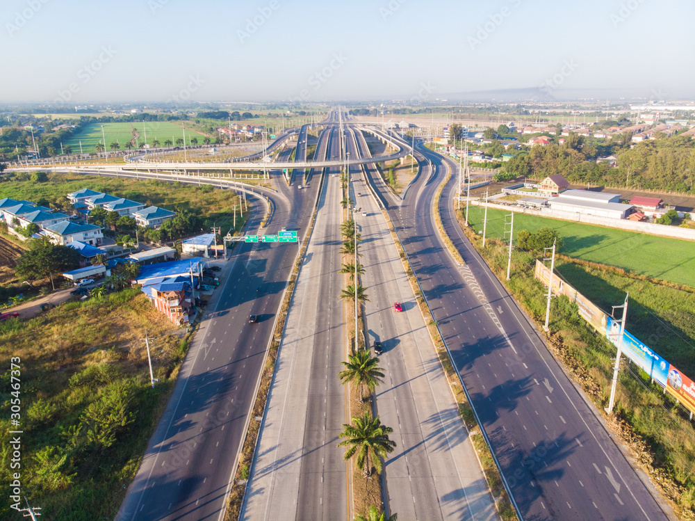Transport junction freeway road with vehicle movement in morning rural of Thailand