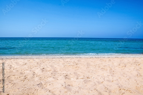 Beautiful view of sandy beach and sea on sunny day