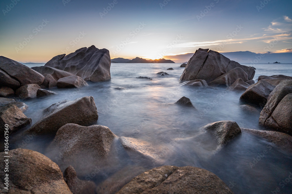 Obraz premium amazing travel landscape photo with Sunset of the iconic rocks of seychelles , Seascape on sea with long exposure and water wave