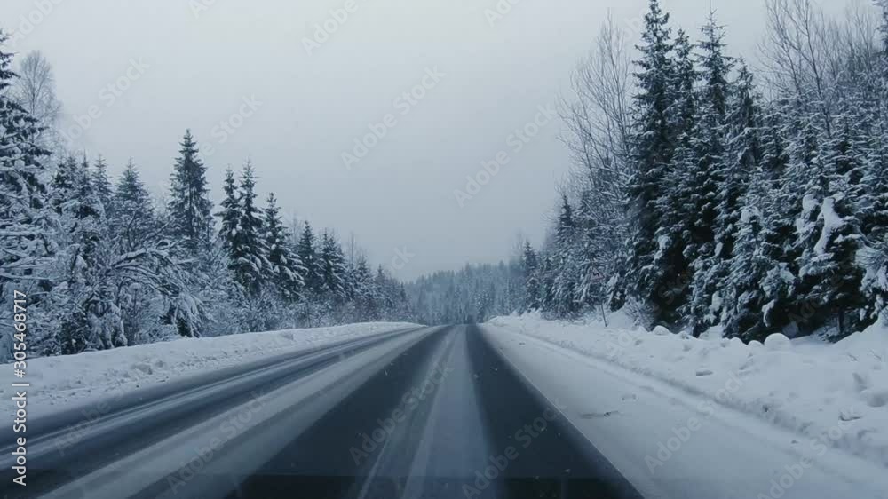 driving on the winter forest road in heavy snowfall, beautiful landscape driving on the winter forest road in heavy snowfall, beautiful landscape
