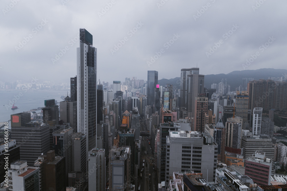 Naklejka premium Hong Kong city landscape day and evening with lights. Skyscrapers overlooking the mountains and the sea day and evening. Night lights. China