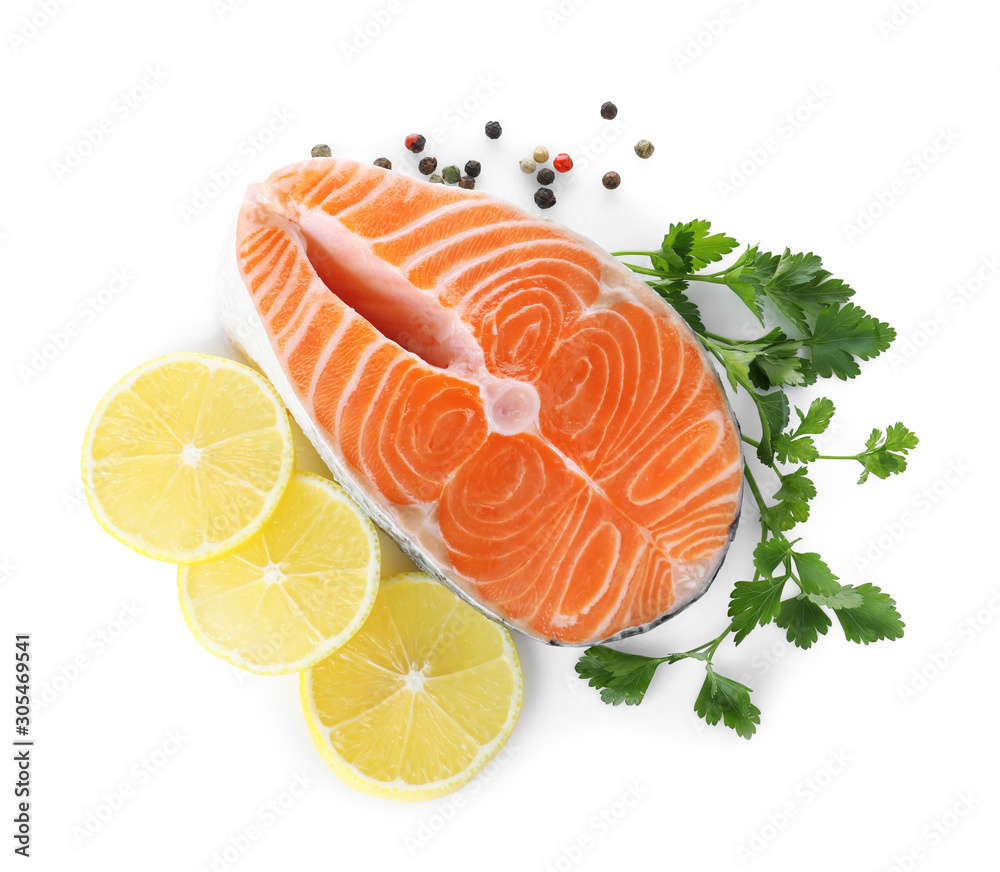 Fresh raw salmon with pepper, lemon and parsley on white background, top view. Fish delicacy Fresh raw salmon with pepper, lemon and parsley on white background, top view. Fish delicacy