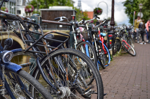 Amsterdam, Holland. August 2019. Bicycles parked along the canals are a symbol of the city. A bike with a red racing frame stands out among the others.