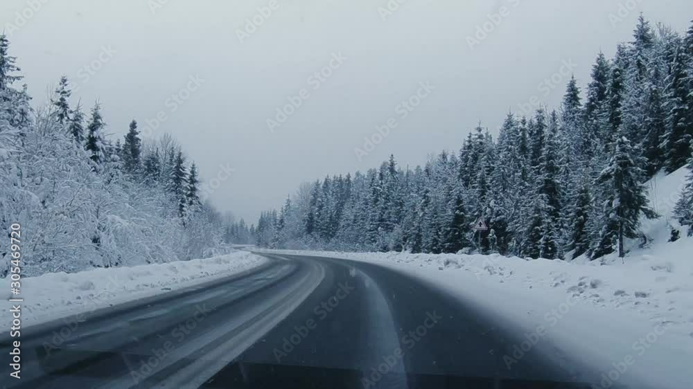 driving on the winter forest road in heavy snowfall, beautiful landscape driving on the winter forest road in heavy snowfall, beautiful landscape