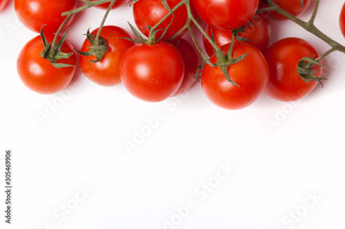Fresh tomatoes on branch on light background