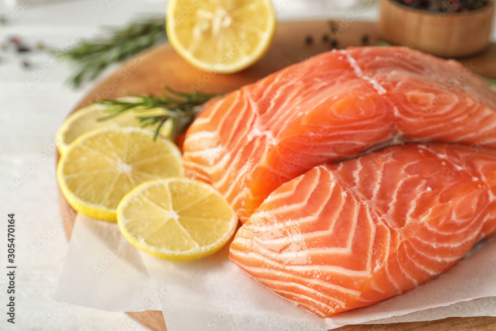 Fresh raw salmon with lemon on table. Fish delicacy Fresh raw salmon with lemon on table. Fish delicacy