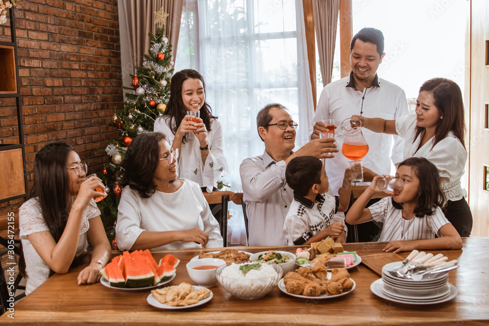 happy asian family tradition having lunch together on christmas day at home happy asian family tradition having lunch together on christmas day at home