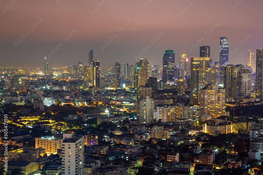 Panorama of cityscape with sunset over the building and blue sky at bangkok ,Thailand. View of the tall building in capital with twilight .Shot using Panorama technique.