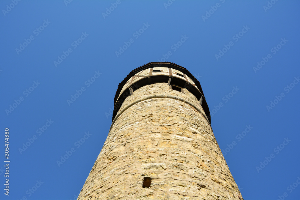 Old tower, bottom-up view, with a lot of blue sky
