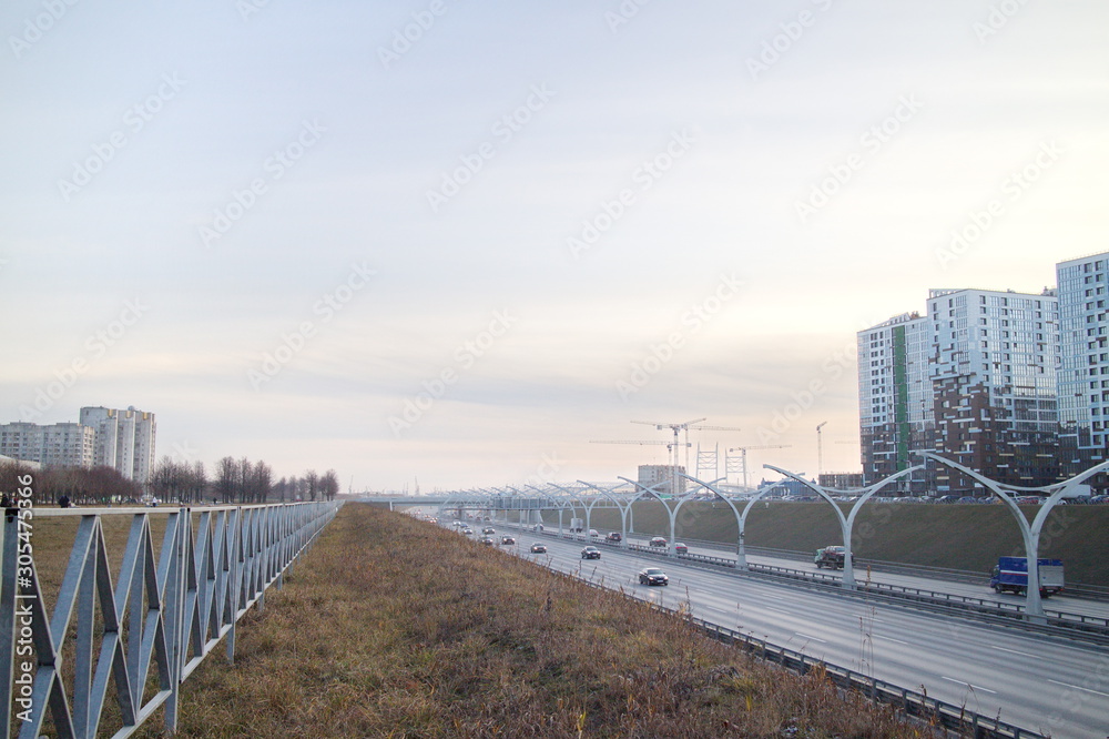 Expressway on the outskirts of the city on a fall evening