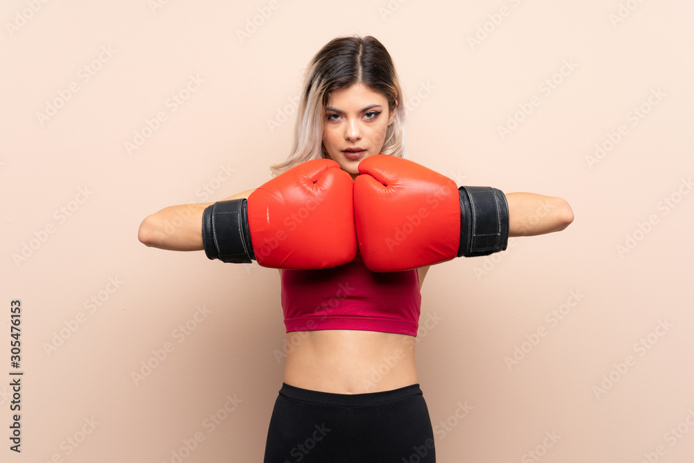 Teenager sport girl over isolated background with boxing gloves